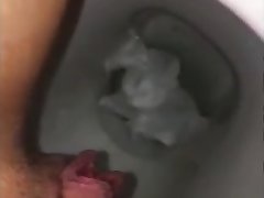 Big pussy lips pissing in someone's skin toilet closeup